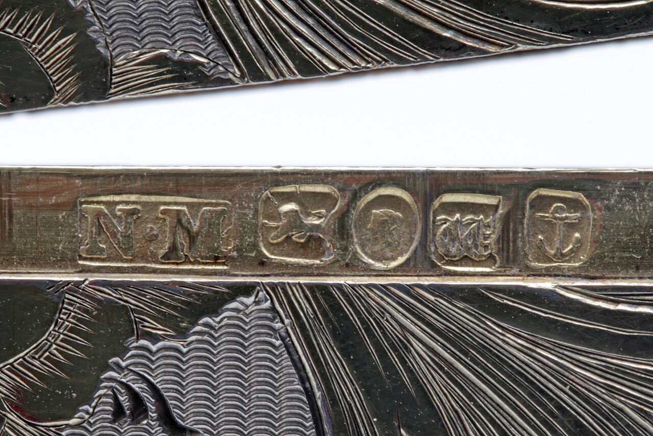 Close-up photograph of a Nathaniel Mills British hallmark row from Birmingham in 1845